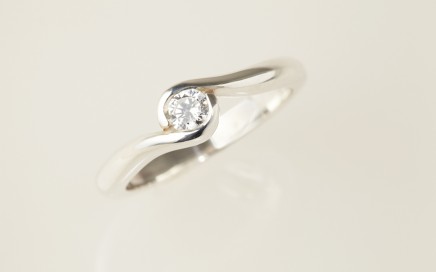 Fairtrade Gold Engagement ring - 2 wave holding a Jeweltree diamond