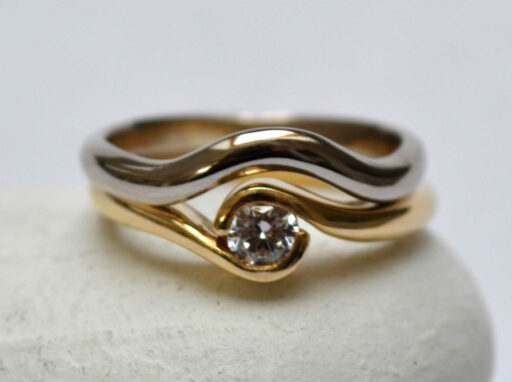 Fairtrade Gold Engagement ring - 2 wave holding a Jeweltree diamond